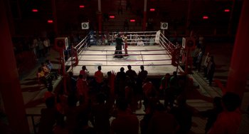 Movie still from “Only God Forgives” (2013), directed by Nicolas Winding Refn – A boxing ring in a boxing ring filled with people; Extreme Wide shot, High angle
