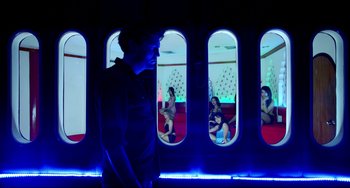 Movie still from “Only God Forgives” (2013), directed by Nicolas Winding Refn – A man standing in front of a group of people; Wide shot, Low angle