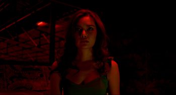 Movie still from “Only God Forgives” (2013), directed by Nicolas Winding Refn – A woman with long red curly hair standing in a dark room; Close Up shot, Low angle