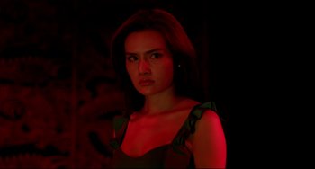 Movie still from “Only God Forgives” (2013), directed by Nicolas Winding Refn – A beautiful woman in a black dress standing in a dark room; Close Up shot, Low angle