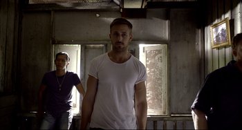 Movie still from “Only God Forgives” (2013), directed by Nicolas Winding Refn – A man and a woman standing next to each other in a room; Medium shot, Low angle