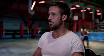 Movie still from “Only God Forgives” (2013), directed by Nicolas Winding Refn – A person wearing a white t - shirt; Close Up shot, Over the shoulder angle