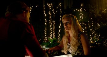 Movie still from “Only God Forgives” (2013), directed by Nicolas Winding Refn – A woman sitting in front of a man at a table; Close Up shot, Over the shoulder angle