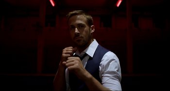 Movie still from “Only God Forgives” (2013), directed by Nicolas Winding Refn – A man wearing a white shirt and a tie; Medium shot, Low angle