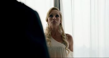 Movie still from “Only God Forgives” (2013), directed by Nicolas Winding Refn – A woman with long blonde hair looking into a mirror; Close Up shot, Over the shoulder angle