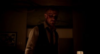 Movie still from “Only God Forgives” (2013), directed by Nicolas Winding Refn – A person wearing a shirt and tie; Medium shot, Low angle