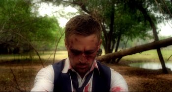 Movie still from “Only God Forgives” (2013), directed by Nicolas Winding Refn – A man with blood all over his face; Close Up shot, Over the shoulder angle
