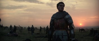 Movie still from “The King” (2019), directed by David Michôd – A man in a chain mail armor; Medium shot, Low angle