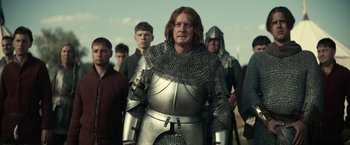 Movie still from “The King” (2019), directed by David Michôd – A group of men in chainmail standing next to each other; Medium shot, Low angle