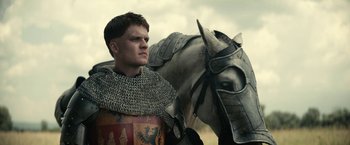 Movie still from “The King” (2019), directed by David Michôd – A man in a helmet and a horse; Close Up shot, Low angle