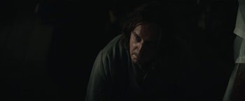 Movie still from “The King” (2019), directed by David Michôd – A man with long dark hair is looking at the camera; Close Up shot, Low angle