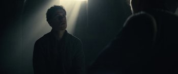 Movie still from “The King” (2019), directed by David Michôd – A man is looking up at the light; Close Up shot, Low angle