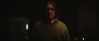 Movie still from “The King” (2019), directed by David Michôd – A man with long brown hair wearing a green shirt; Close Up shot, Low angle