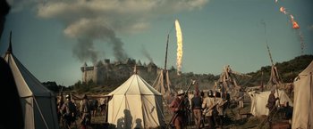 Movie still from “The King” (2019), directed by David Michôd – A group of people standing next to each other near a tent; Extreme Wide shot, Low angle