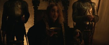 Movie still from “The King” (2019), directed by David Michôd – A man holding a bowl in a dark room; Medium shot, Over the shoulder angle