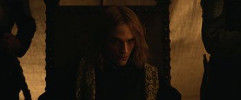 Movie still from “The King” (2019), directed by David Michôd – A person with long hair is looking at the camera; Close Up shot, Over the shoulder angle
