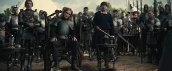 Movie still from “The King” (2019), directed by David Michôd – A group of people dressed in medieval clothing; Wide shot, Over the shoulder angle