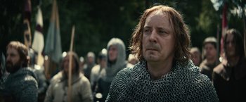 Movie still from “The King” (2019), directed by David Michôd – A group of people in chain mail standing next to each other; Close Up shot, Over the shoulder angle