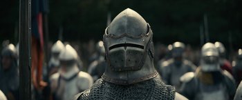 Movie still from “The King” (2019), directed by David Michôd – A person wearing a metal helmet; Close Up shot, Low angle