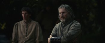 Movie still from “The King” (2019), directed by David Michôd – A man with long grey hair and a gray beard; Close Up shot, Over the shoulder angle