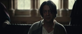 Movie still from “The King” (2019), directed by David Michôd – A person with long black hair; Close Up shot, Over the shoulder angle