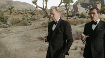 Movie still from “The Laundromat” (2019), directed by Steven Soderbergh – A man in a tuxedo holding a glass of wine; Medium shot, Low angle