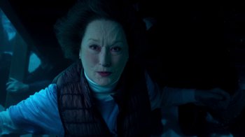 Movie still from “The Laundromat” (2019), directed by Steven Soderbergh – An older woman is looking at the camera; Close Up shot, Overhead angle