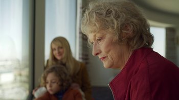 Movie still from “The Laundromat” (2019), directed by Steven Soderbergh – An older woman sitting next to a young girl; Close Up shot, Over the shoulder angle