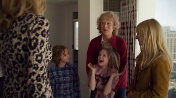 Movie still from “The Laundromat” (2019), directed by Steven Soderbergh – An older woman standing next to two young children; Medium shot, Over the shoulder angle