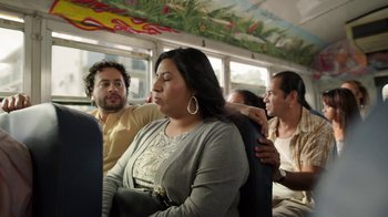 Movie still from “The Laundromat” (2019), directed by Steven Soderbergh – A group of people sitting on a bus together; Medium shot, Over the shoulder angle