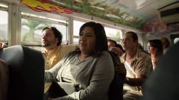 Movie still from “The Laundromat” (2019), directed by Steven Soderbergh – A group of people sitting in a bus; Medium shot, Over the shoulder angle
