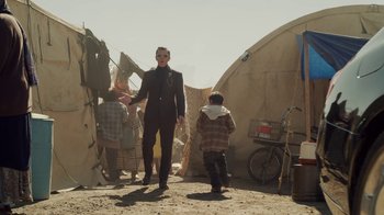 Movie still from “The Laundromat” (2019), directed by Steven Soderbergh – A man and a child in front of a tent; Wide shot, Over the shoulder angle