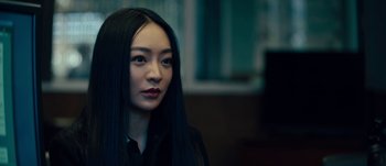 Movie still from “The Laundromat” (2019), directed by Steven Soderbergh – A woman with long black hair wearing a black shirt; Close Up shot, Over the shoulder angle