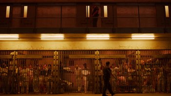 Movie still from “The Laundromat” (2019), directed by Steven Soderbergh – A group of people standing in front of a jail cell; Extreme Wide shot, High angle