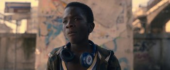Movie still from “The Life Ahead” (2020), directed by Edoardo Ponti – A young man wearing headphones and looking into the distance; Close Up shot, Over the shoulder angle