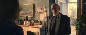 Movie still from “The Life Ahead” (2020), directed by Edoardo Ponti – An older man standing in front of a desk; Medium shot, Over the shoulder angle