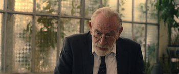 Movie still from “The Life Ahead” (2020), directed by Edoardo Ponti – An older man wearing a suit and tie; Close Up shot, Over the shoulder angle