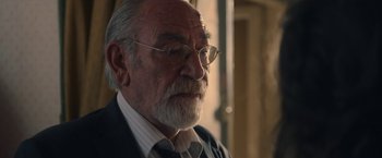 Movie still from “The Life Ahead” (2020), directed by Edoardo Ponti – An old man with a beard wearing glasses and a suit; Close Up shot, Over the shoulder angle