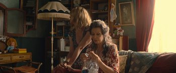 Movie still from “The Life Ahead” (2020), directed by Edoardo Ponti – Two women sitting in a living room with a lamp; Medium shot, High angle