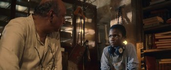 Movie still from “The Life Ahead” (2020), directed by Edoardo Ponti – A man talking to a young boy in a room; Close Up shot, Over the shoulder angle