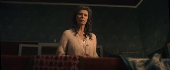 Movie still from “The Life Ahead” (2020), directed by Edoardo Ponti – A woman standing in front of a table with presents on top of it; Medium shot, Low angle