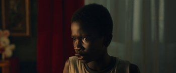 Movie still from “The Life Ahead” (2020), directed by Edoardo Ponti – A young black boy is looking at the camera; Close Up shot, Low angle