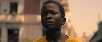 Movie still from “The Life Ahead” (2020), directed by Edoardo Ponti – A person wearing a yellow shirt; Close Up shot, Low angle