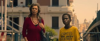Movie still from “The Life Ahead” (2020), directed by Edoardo Ponti – A woman standing next to a young boy; Medium shot, Low angle