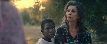 Movie still from “The Life Ahead” (2020), directed by Edoardo Ponti – An older woman standing next to a young boy; Close Up shot, Over the shoulder angle