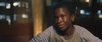 Movie still from “The Life Ahead” (2020), directed by Edoardo Ponti – A young boy sitting in front of a window; Close Up shot, Over the shoulder angle
