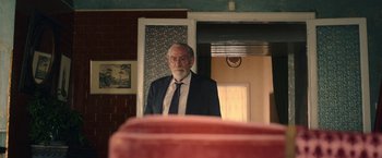 Movie still from “The Life Ahead” (2020), directed by Edoardo Ponti – An older man is standing in front of a mirror; Medium shot, Over the shoulder angle