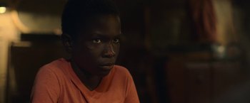 Movie still from “The Life Ahead” (2020), directed by Edoardo Ponti – A young black man looking into the distance; Close Up shot, Over the shoulder angle