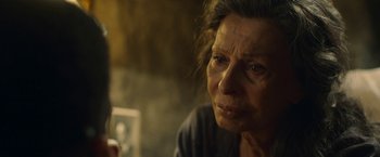 Movie still from “The Life Ahead” (2020), directed by Edoardo Ponti – An older woman looking sad while sitting in a chair; Close Up shot, Over the shoulder angle