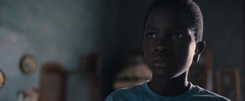 Movie still from “The Life Ahead” (2020), directed by Edoardo Ponti – A young person looking at the camera; Close Up shot, Over the shoulder angle